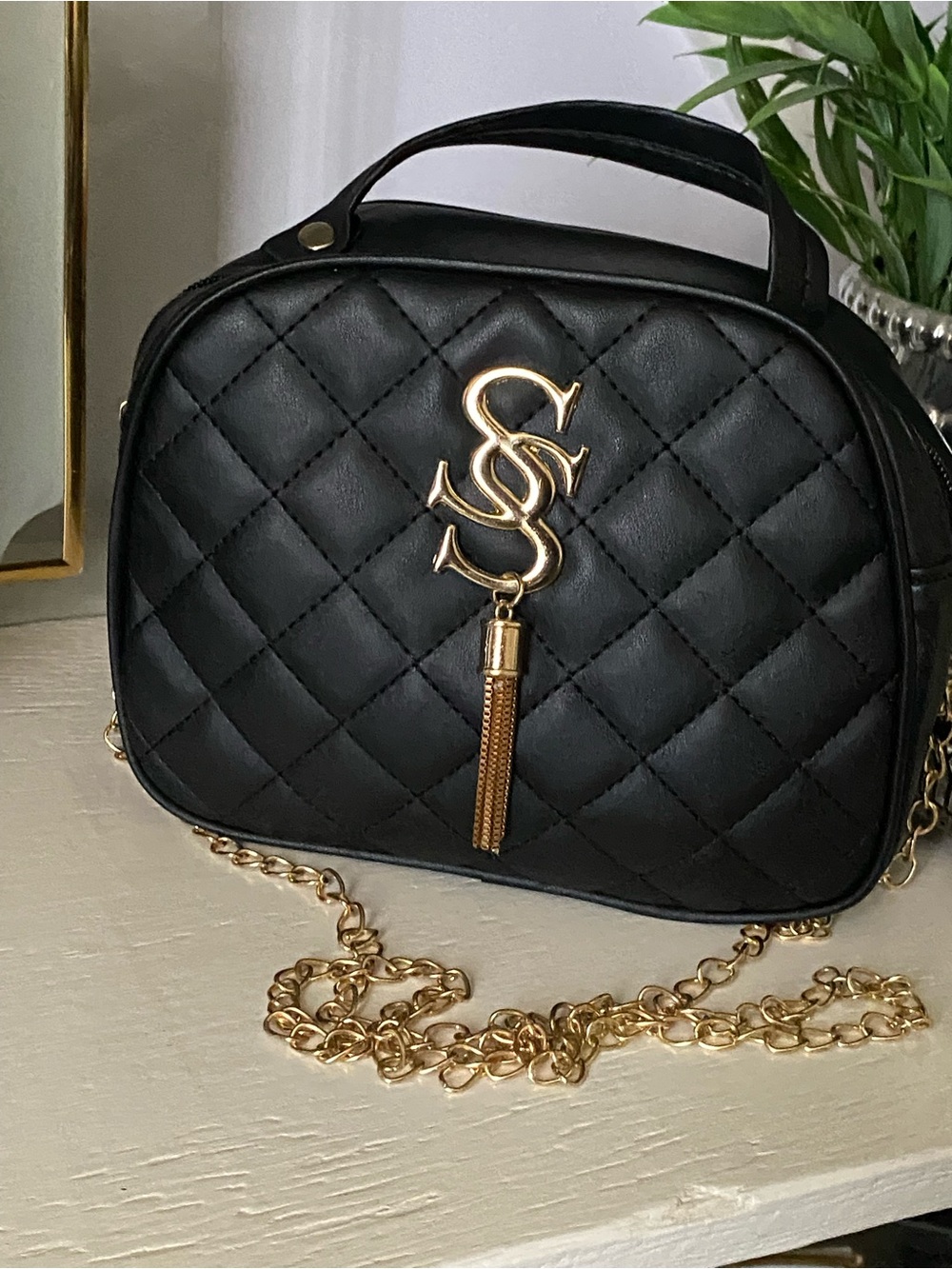 Quilted Black Crossbody Bag with Gold Tassel Accent